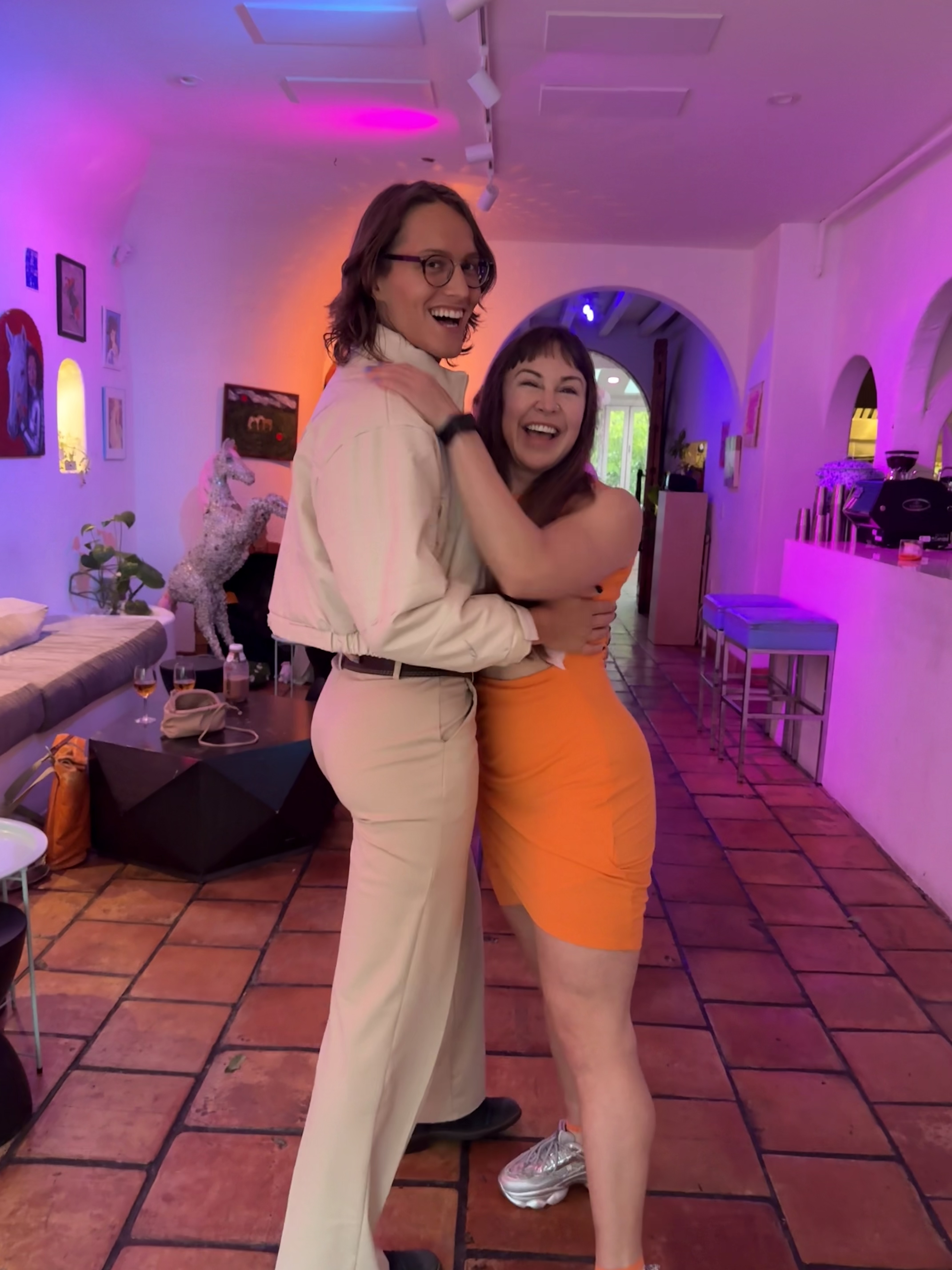 Mars and Andrea embracing and laughing together
